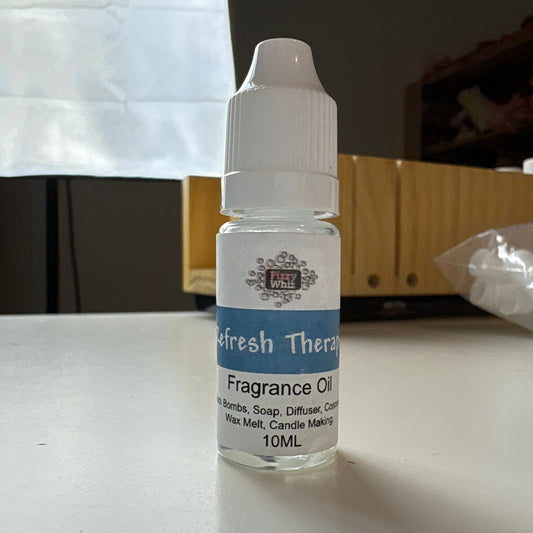Fragrance oil bottle on a white surface with a blurred background