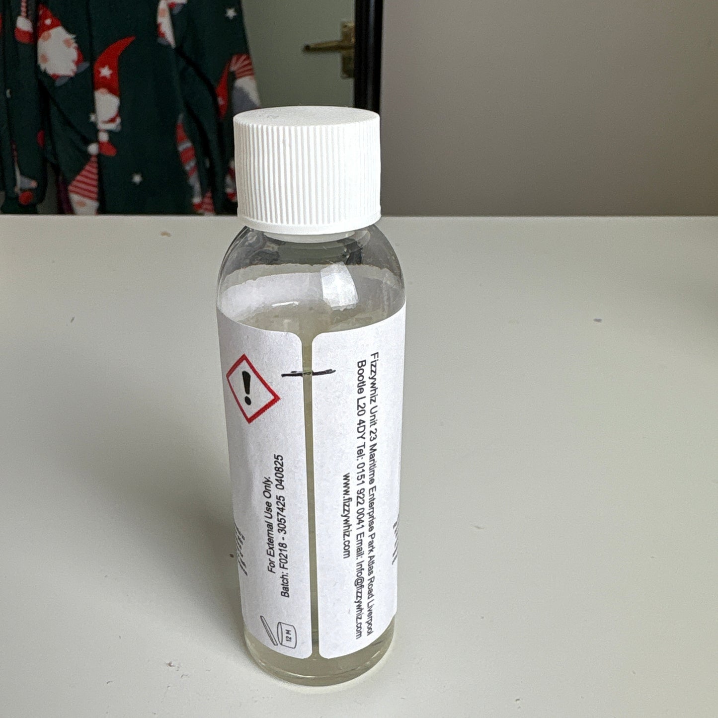 Small bottle with a label on a white surface