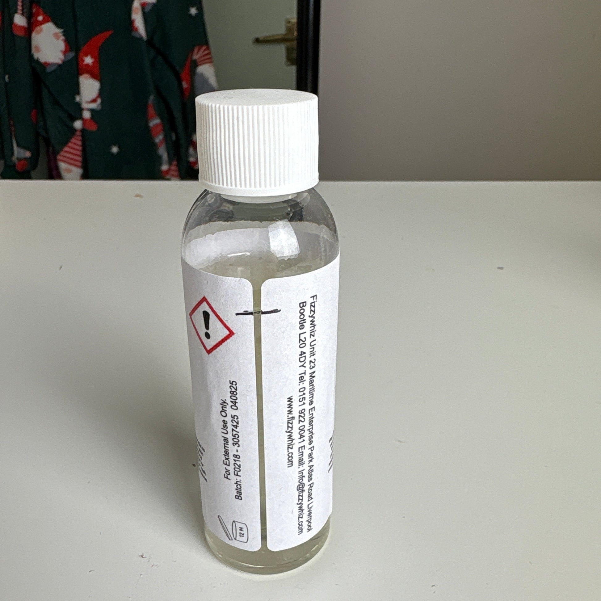 Small bottle with a label on a white surface