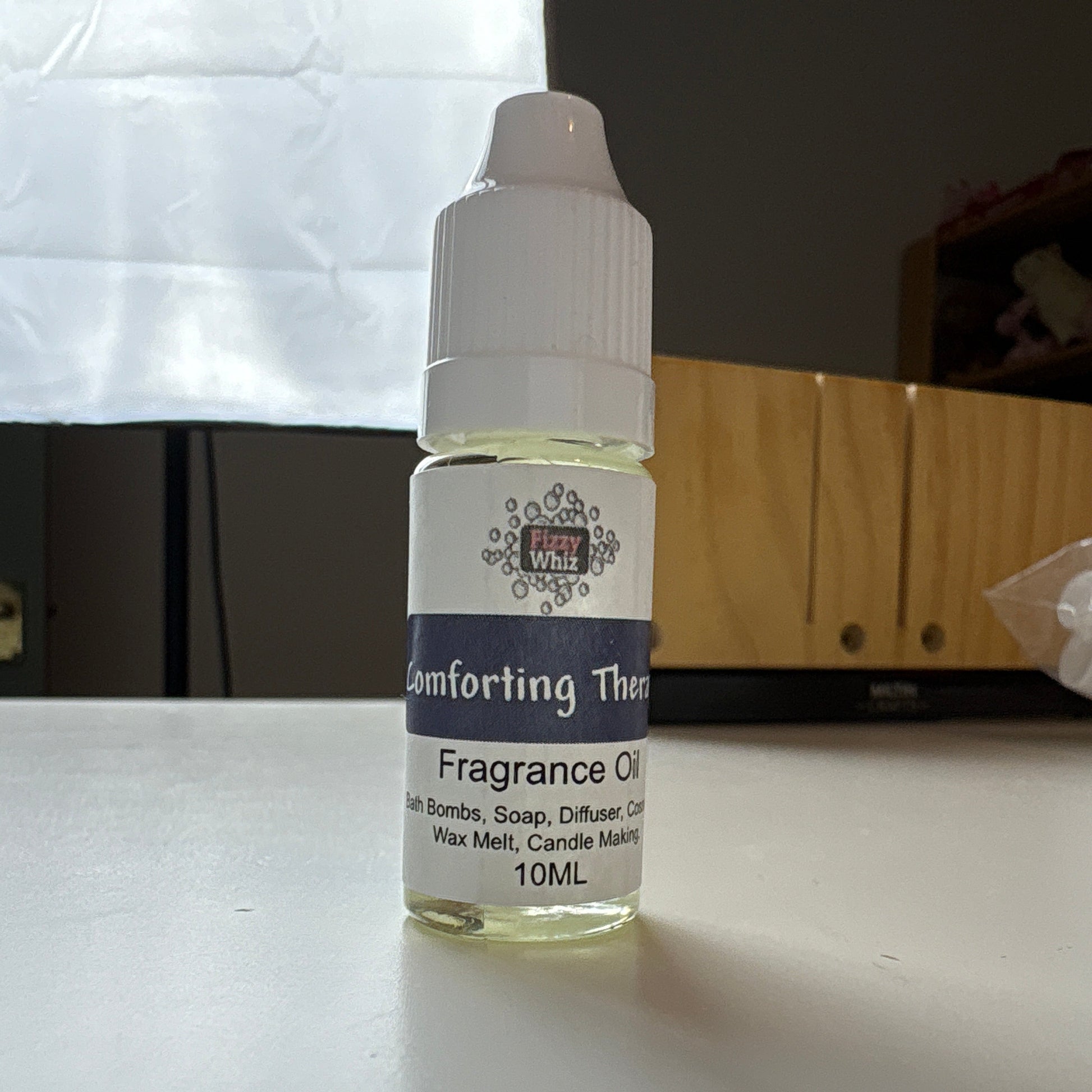 Small bottle of fragrance oil on a white surface